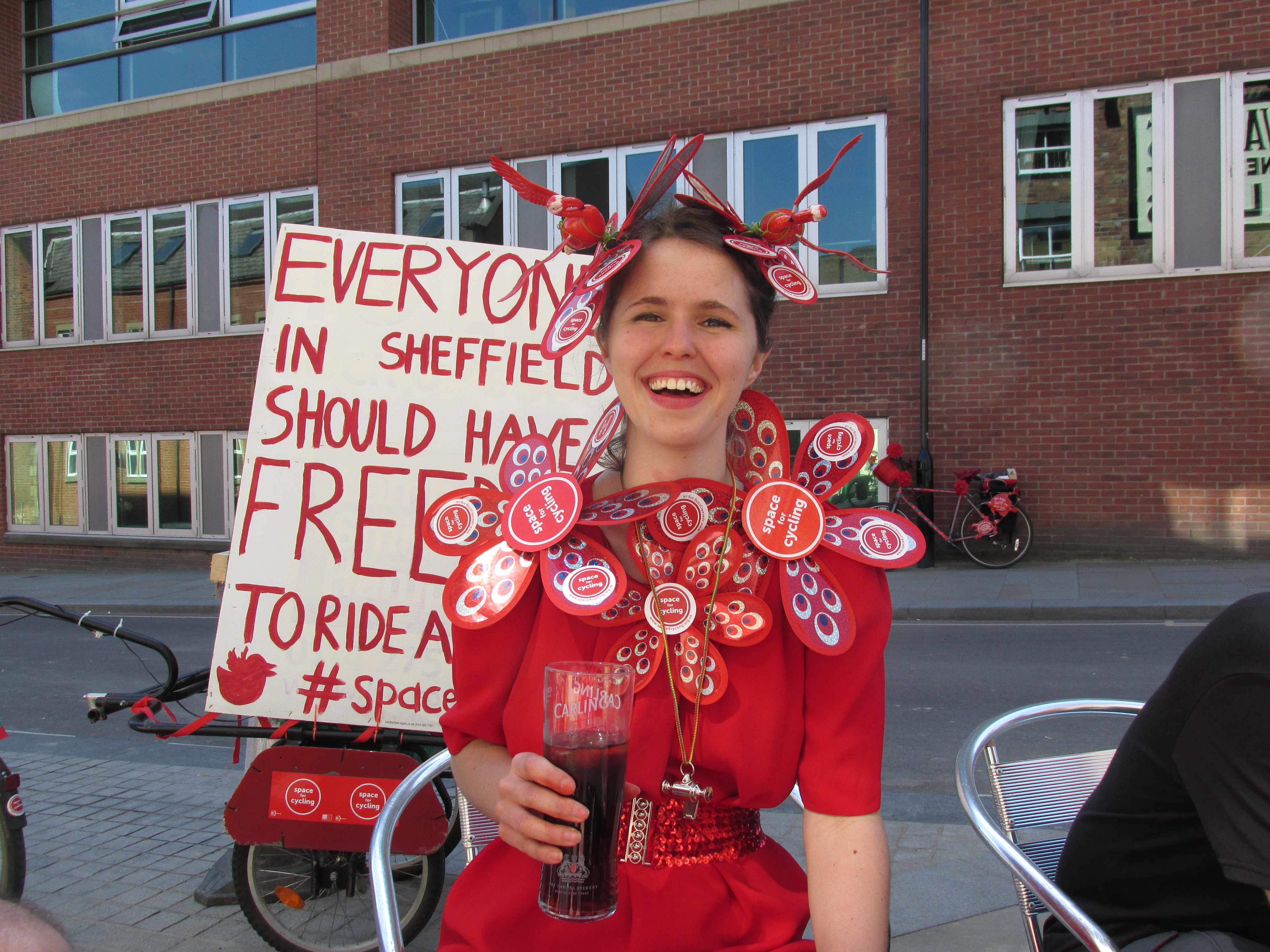 Emma Metcalfe in her #space4cycling head-dress. Celebrating after the ride with a pint of Coke. Credit - Paul Truin